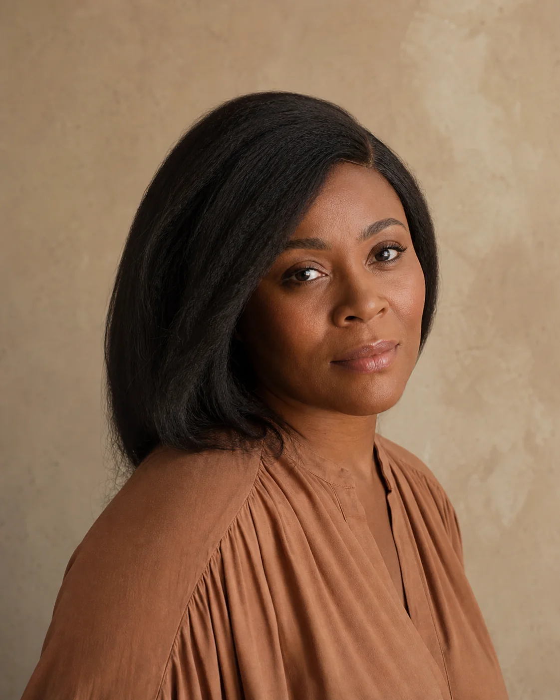 Illustrative portrait of a Black woman with a natural, modest-density straight textured style