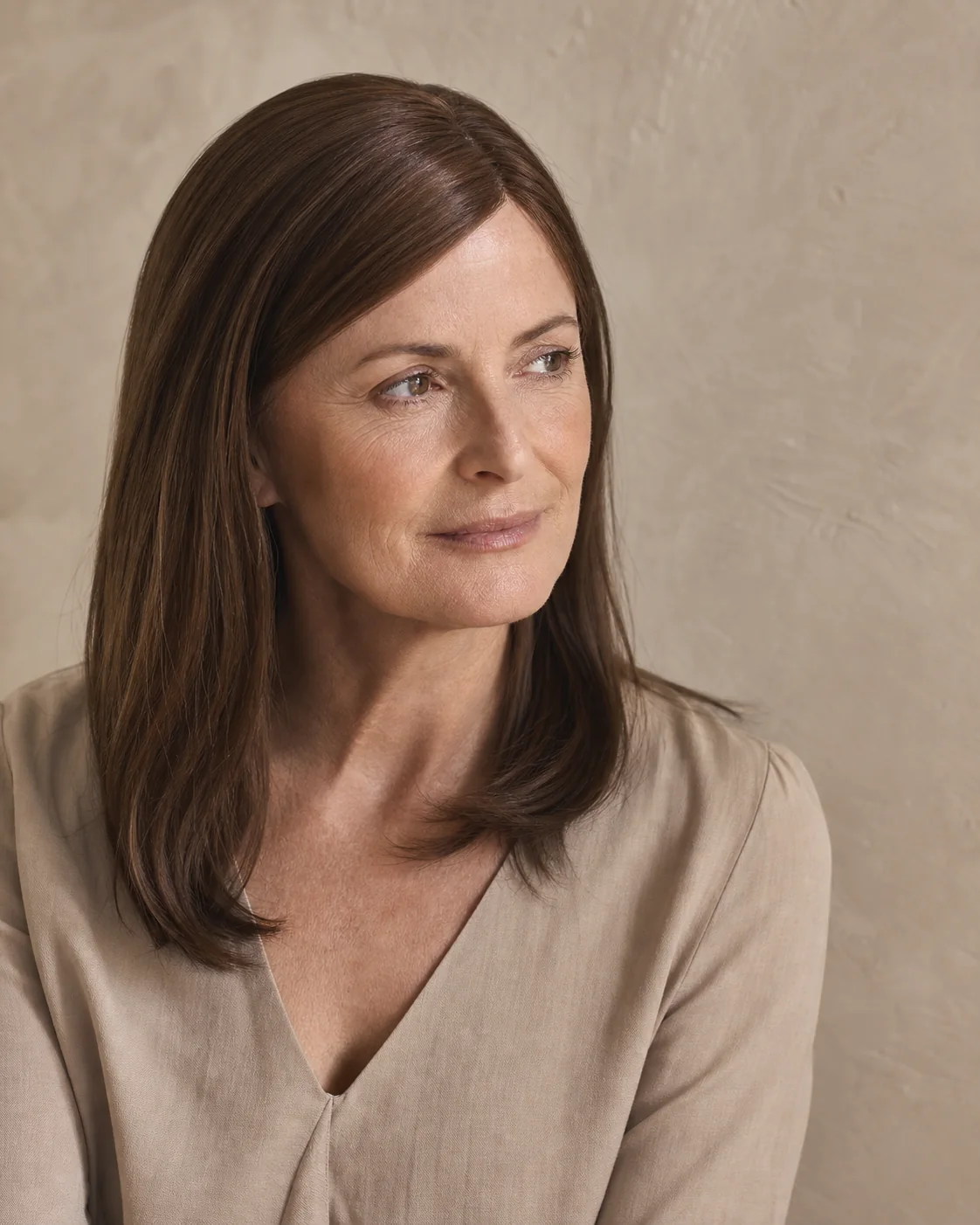 Illustrative portrait showing a natural straight medium-brown style