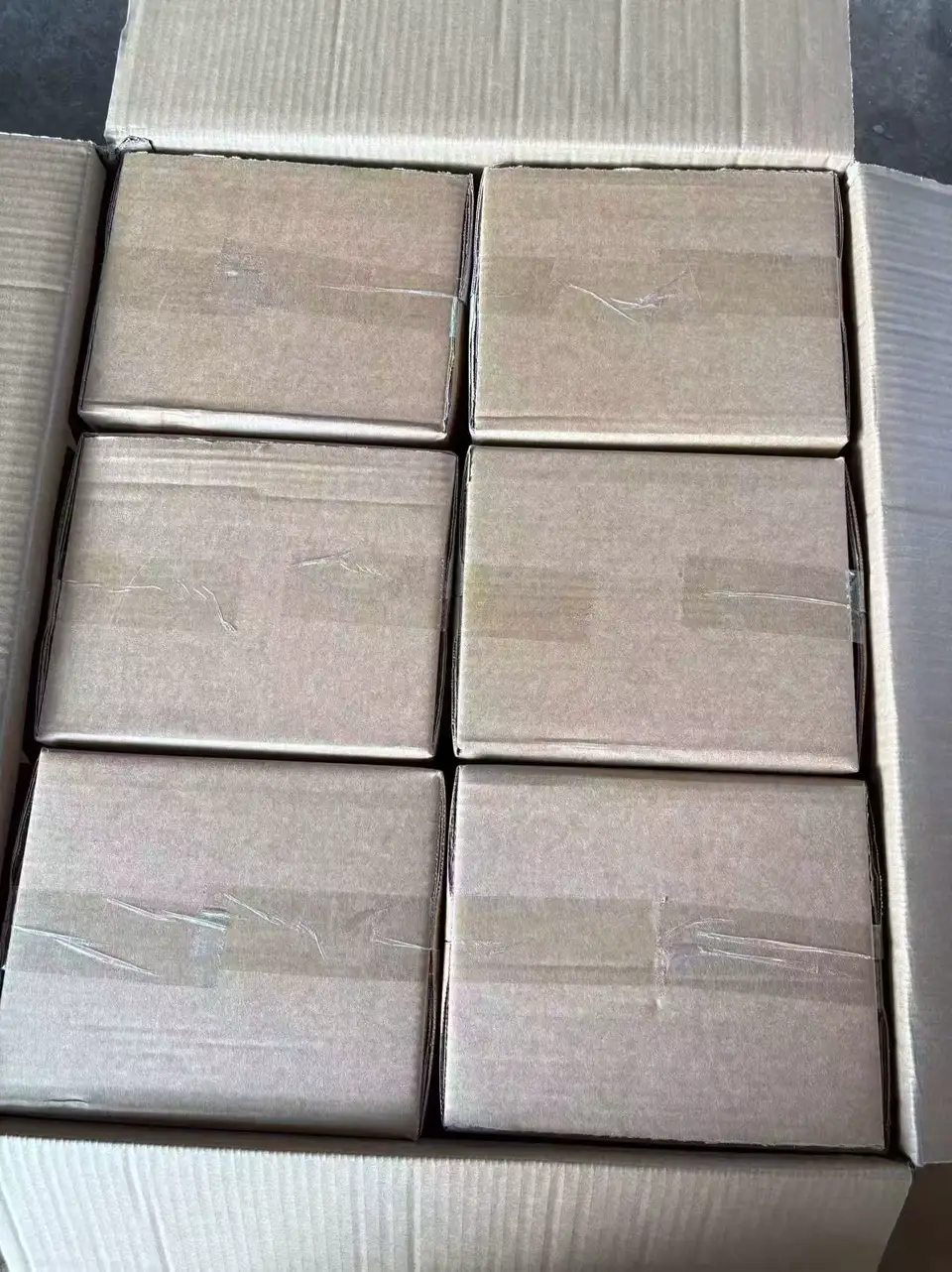 Six individual taped cartons arranged inside an open outer carton