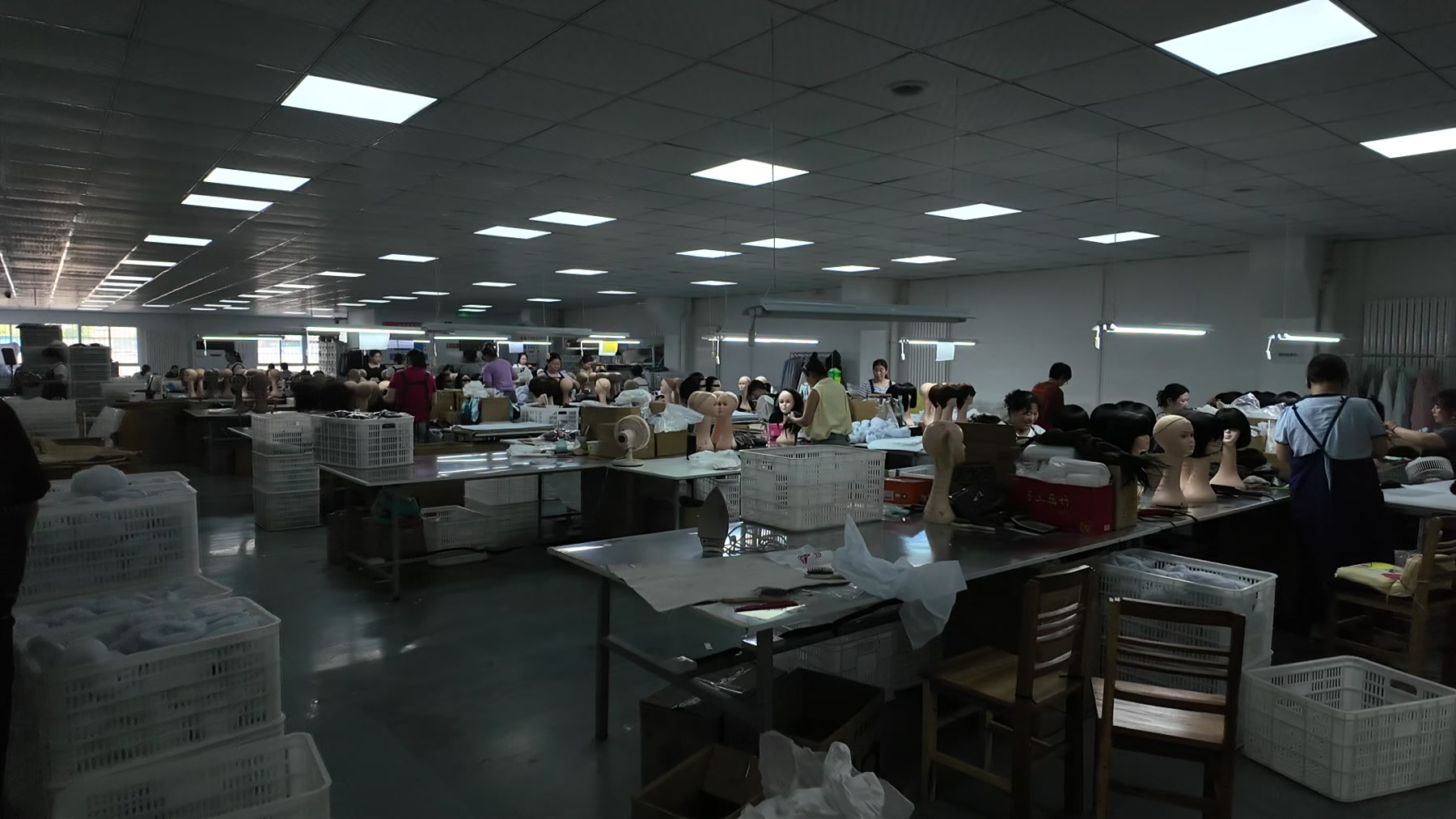 Wig workstations and workers in a supplier workshop